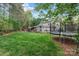 A spacious backyard with lush green grass and mature trees, featuring a trampoline at 1509 Kirkbridge Ct, Matthews, NC 28105