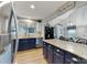 Spacious kitchen with granite countertops, stainless steel appliances, blue cabinets, and eat in area at 1509 Kirkbridge Ct, Matthews, NC 28105