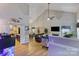 Bright open-concept featuring a fireplace, vaulted ceiling, and view of the kitchen and dining room at 1509 Kirkbridge Ct, Matthews, NC 28105