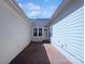 View of backyard featuring brick patio and a back door at 151 Harper Lee St, Davidson, NC 28036