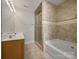 Well-lit bathroom with double sink vanity, a shower, and a soaking tub at 151 Harper Lee St, Davidson, NC 28036