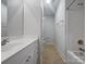 Bright bathroom showcasing a white vanity, shower, and tub, designed for relaxation and convenience at 151 Harper Lee St, Davidson, NC 28036