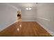 Spacious dining room with hardwood floors, a modern chandelier, and neutral walls offering versatile design possibilities at 151 Harper Lee St, Davidson, NC 28036