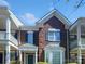 Charming two-story brick townhome with beautiful architectural details and well-maintained landscaping at 151 Harper Lee St, Davidson, NC 28036