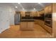 Well-equipped kitchen featuring stainless steel appliances, granite countertops, a center island, and ample storage at 151 Harper Lee St, Davidson, NC 28036