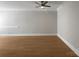 Spacious living room featuring wood floors and a modern ceiling fan for comfortable living at 151 Harper Lee St, Davidson, NC 28036