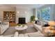 Bright living room with a cozy fireplace, large windows, and stylish decor showcasing a comfortable space at 151 Harper Lee St, Davidson, NC 28036