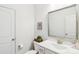Clean half bathroom with white vanity, sink, and toilet and neutral decor at 15108 Autumn Sage Dr, Charlotte, NC 28278