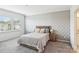 Cozy bedroom with neutral walls, plush carpet, a window and a bed with soft bedding at 15108 Autumn Sage Dr, Charlotte, NC 28278