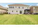 Exterior back of house with large lawn and covered patio at 15108 Autumn Sage Dr, Charlotte, NC 28278