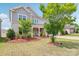 Inviting two-story home featuring a manicured front yard, attractive landscaping, and a welcoming entrance at 15108 Autumn Sage Dr, Charlotte, NC 28278