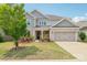 Charming two-story home with brick and gray siding, a well-manicured lawn, and an attached two-car garage at 15108 Autumn Sage Dr, Charlotte, NC 28278