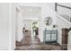 Bright foyer featuring wood floors, staircase, and a decorative cabinet at 15108 Autumn Sage Dr, Charlotte, NC 28278