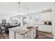 Open-concept kitchen island with granite countertop, pendant lighting, and stainless steel appliances at 15108 Autumn Sage Dr, Charlotte, NC 28278