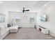 Spacious living room with a white sectional sofa, large TV, and plush carpeting at 15108 Autumn Sage Dr, Charlotte, NC 28278
