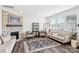 Cozy living room featuring a stone fireplace, ample natural light, and comfortable seating at 15108 Autumn Sage Dr, Charlotte, NC 28278