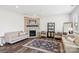 Comfortable living room with a stone fireplace and stylish decor at 15108 Autumn Sage Dr, Charlotte, NC 28278