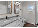 Bathroom featuring a dual sink vanity with granite countertops and modern fixtures at 15700 Stokes Ferry Rd, Richfield, NC 28137