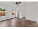 Bright bedroom with wood-look floors, light gray walls, and natural light from two windows at 15700 Stokes Ferry Rd, Richfield, NC 28137