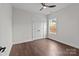 This bedroom features hardwood floors, a ceiling fan, and a bright window at 15700 Stokes Ferry Rd, Richfield, NC 28137