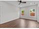 Bright bedroom with wood-look floors, light gray walls, and natural light from two windows at 15700 Stokes Ferry Rd, Richfield, NC 28137