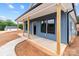 Charming blue home featuring a cozy front porch with wooden columns and a well-manicured walkway at 15700 Stokes Ferry Rd, Richfield, NC 28137