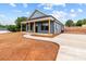 Single-story home showcasing a covered porch, modern blue siding, and a well-manicured lawn at 15700 Stokes Ferry Rd, Richfield, NC 28137
