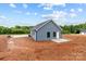 Newly constructed blue home with concrete patio, set on a spacious dirt lot, ready for landscaping at 15700 Stokes Ferry Rd, Richfield, NC 28137
