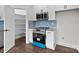 Bright kitchen featuring white cabinets, stainless steel appliances, and a stylish blue backsplash at 15700 Stokes Ferry Rd, Richfield, NC 28137