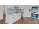 Bright kitchen featuring white cabinets, stainless steel appliances, and a stylish blue backsplash at 15700 Stokes Ferry Rd, Richfield, NC 28137