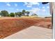 View of a red dirt lot with a concrete section, landscaping potential and surrounding homes at 15700 Stokes Ferry Rd, Richfield, NC 28137
