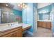 Bright bathroom features double vanity, a makeup counter, tile floors and shower with glass door at 16919 Hedgerow Park Rd, Charlotte, NC 28277