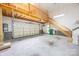 Spacious garage features a staircase to a loft and a separate enclosed storage room at 16919 Hedgerow Park Rd, Charlotte, NC 28277