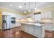 Spacious kitchen with white cabinets, granite countertops, stainless steel appliances, and a large center island at 16919 Hedgerow Park Rd, Charlotte, NC 28277