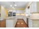 Well-equipped kitchen with white cabinetry, granite countertops, stainless steel appliances, and an island with pendant lighting at 16919 Hedgerow Park Rd, Charlotte, NC 28277