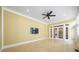 Bright sunroom featuring tile floors, ceiling fan, and double doors at 16919 Hedgerow Park Rd, Charlotte, NC 28277