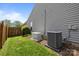 Backyard featuring a well-kept lawn, perimeter fence, generator, and AC unit at 2006 Holly Villa Cir, Indian Trail, NC 28079