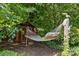 Relaxing backyard space featuring a hammock and storage shed at 2006 Holly Villa Cir, Indian Trail, NC 28079