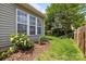 Landscaped backyard, showcasing the home's exterior, manicured lawn and privacy fence at 2006 Holly Villa Cir, Indian Trail, NC 28079