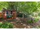 View of shed, yard waste container and hammock in a shaded backyard at 2006 Holly Villa Cir, Indian Trail, NC 28079