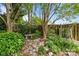 Landscaped backyard retreat featuring lush garden, stone pathway and privacy fence at 2006 Holly Villa Cir, Indian Trail, NC 28079