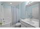 Cozy bathroom with a shower-tub combo, a white vanity, and blue wall at 2006 Holly Villa Cir, Indian Trail, NC 28079