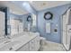 Bright bathroom with double vanity, blue walls, and a shower at 2006 Holly Villa Cir, Indian Trail, NC 28079