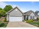 Charming home with a two-car garage, gray siding, and well-maintained landscaping at 2006 Holly Villa Cir, Indian Trail, NC 28079