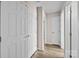 Hallway featuring a hardwood floor, neutral paint, and doors to rooms and closets at 2006 Holly Villa Cir, Indian Trail, NC 28079