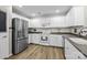 Well-lit kitchen with stainless steel appliances and ample white cabinetry at 2006 Holly Villa Cir, Indian Trail, NC 28079