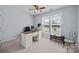 Office featuring carpet, modern desk, fan, and a large window for natural light at 2006 Holly Villa Cir, Indian Trail, NC 28079
