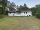 Expansive backyard view showcases the home’s screened porch and a lush green lawn at 201 Harley St, Wadesboro, NC 28170