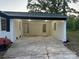 Covered carport providing convenient parking and easy access to the house with a well-kept lawn at 201 Harley St, Wadesboro, NC 28170