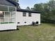 The house features a brick facade, black trim, a screened porch and a well-maintained lawn at 201 Harley St, Wadesboro, NC 28170